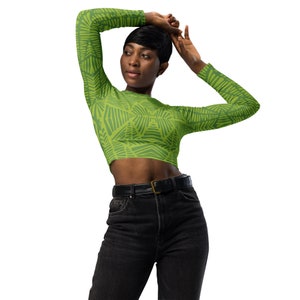 May include: A green long-sleeved crop top with a geometric pattern. The top is made of a stretchy fabric and has a fitted silhouette.