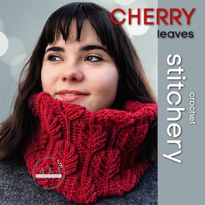 May include: A close-up of a red crochet cowl with a leaf pattern. The cowl is around the neck of a person. The words "CHERRY leaves stitchery crochet" are in the image. The cowl is a deep red color.