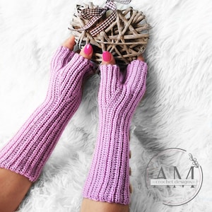 May include: A pair of long, pink fingerless gloves with a button detail. The gloves are crocheted and have a ribbed texture.