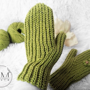 May include: A pair of green crocheted mittens with a ribbed texture. One mitten has a button detail.