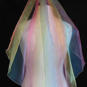 May include: A rainbow tulle veil with a sheer, layered design. The veil is made of soft, lightweight fabric and has a delicate, ethereal look.