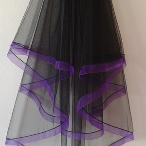 May include: Black tulle veil with multiple layers of purple ribbon trim.