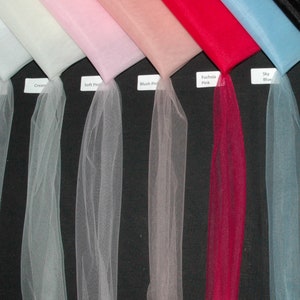 May include: A selection of tulle fabric swatches in various colors, including white, ivory, cream, soft pink, blush pink, fuchsia pink, sky blue, black, and silver grey.
