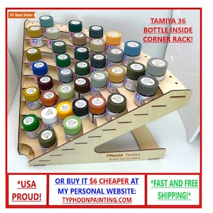 May include: A wooden corner rack designed to hold 36 Tamiya paint bottles. The rack is made of light-colored wood and features multiple shelves. The text "TAMIYA 36 BOTTLE INSIDE CORNER RACK!" is visible on the image.