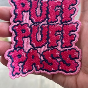 May include: Pink and red embroidered patch with the text "Puff Puff Pass" in a bubble-like font.
