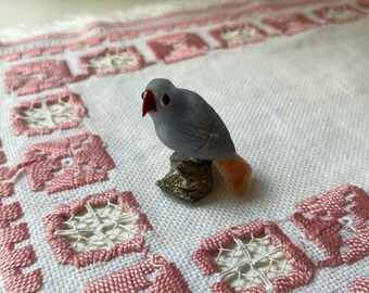 carved stone bird atop of golden nugget
