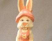 Easter Bunny dressed in pink with pink bonnet, hand carved in wood