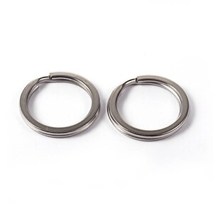May include: Two silver key rings, each with a double-loop design.