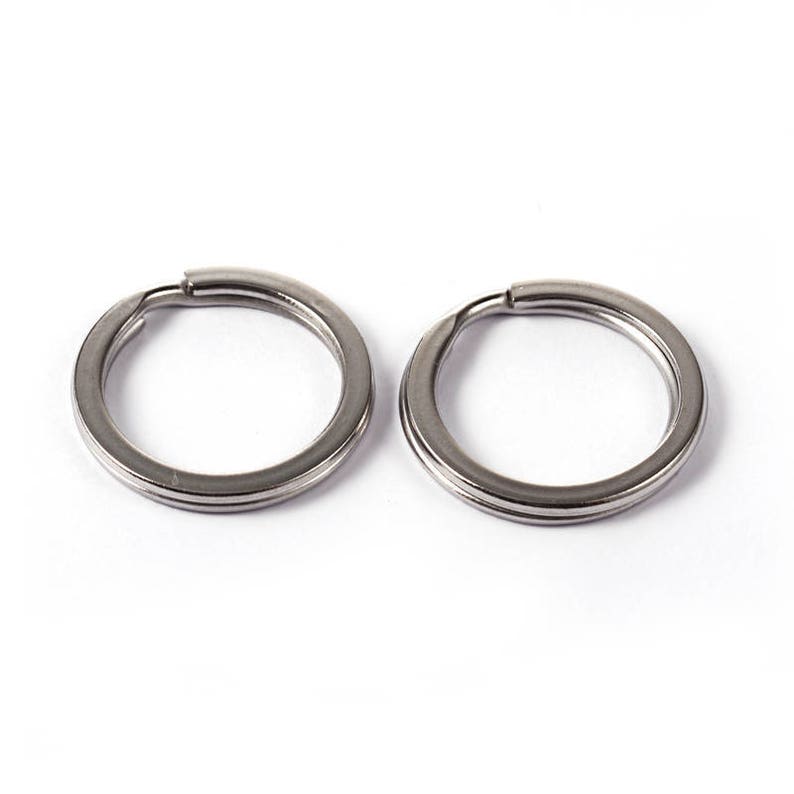 May include: Two silver key rings, each with a double-loop design.