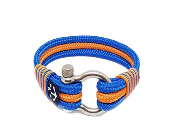 May include: A blue and orange rope bracelet with a silver anchor clasp. The bracelet is made of two strands of rope, one blue and one orange, that are woven together. The anchor clasp is a simple design with a small screw on the top.