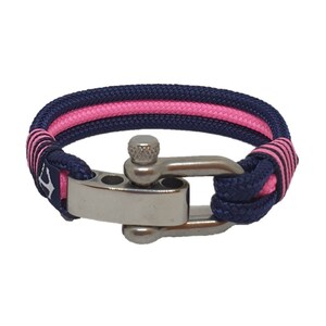 May include: A navy blue and pink rope bracelet with a stainless steel clasp. The bracelet is made of two strands of rope, one navy blue and one pink, that are woven together.