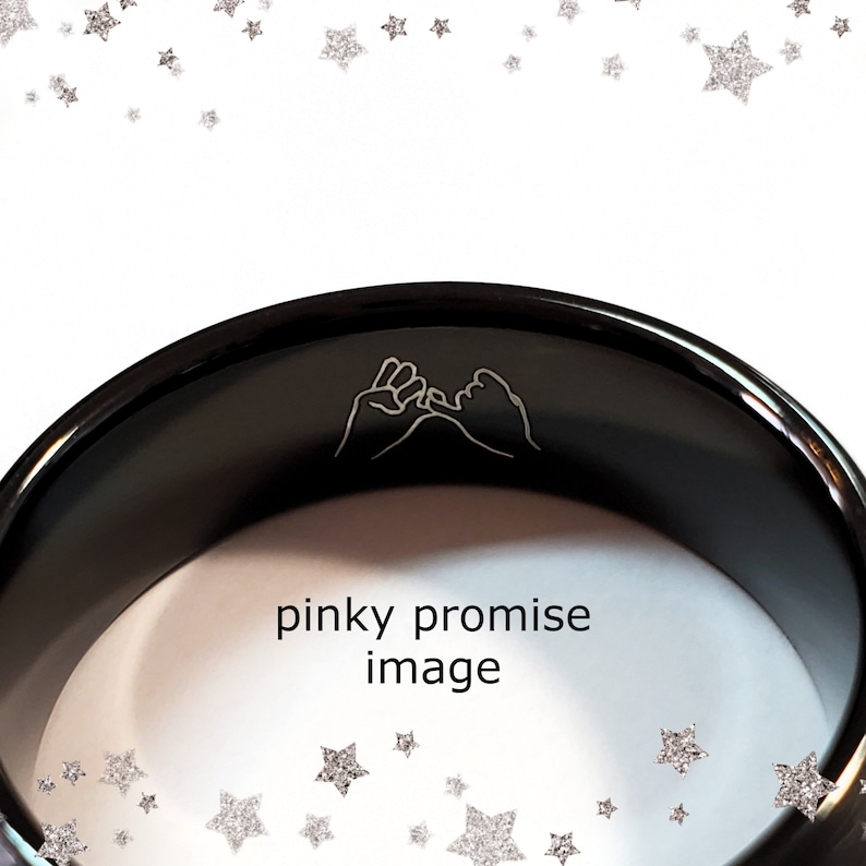 May include: Black ring with a pinky promise design engraved on the inside. The ring is made of a smooth, polished metal.