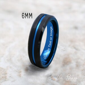 May include: A black and blue tungsten carbide ring with a beveled edge and a blue inlay. The ring is 6mm wide and can be engraved with custom text or an image.