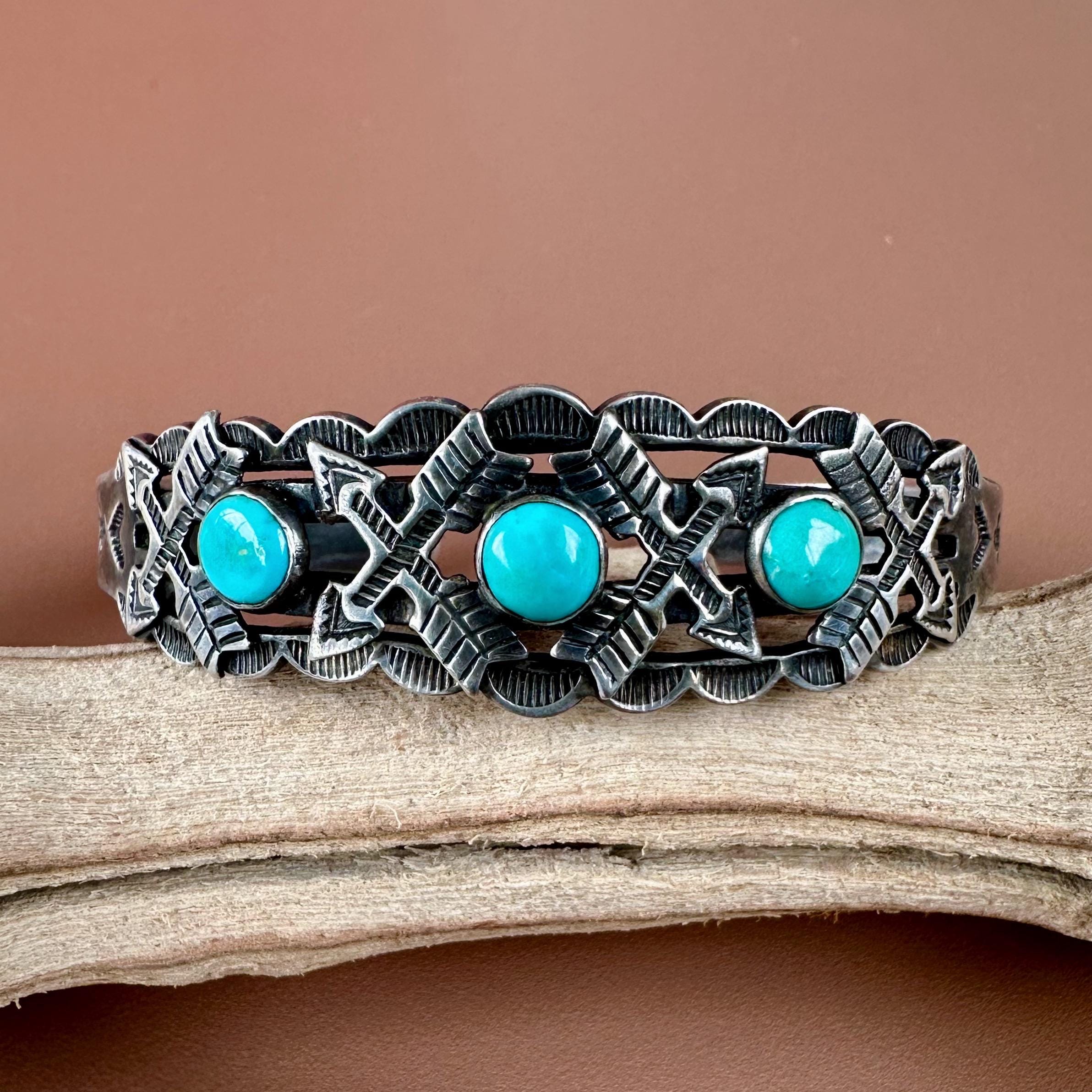 Vintage Fred Harvey era Navajo sterling silver and three stone turquoise cuff bracelet with crossed arrows appliqués