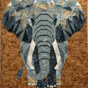 May include: A geometric patchwork quilt featuring a large gray elephant with white tusks. The elephant is standing on a brown background with a swirling pattern.