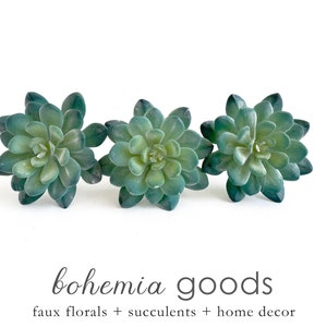 May include: Three artificial succulent plants in a green hue, arranged in a row on a white background. The text "bohemia goods" and "faux florals + succulents + home decor" is displayed below the plants.