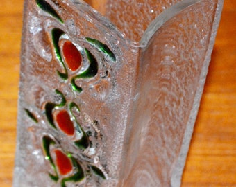 May include: A clear glass vase with a textured surface and a design of red and green swirls. The vase is rectangular with a slightly curved top.