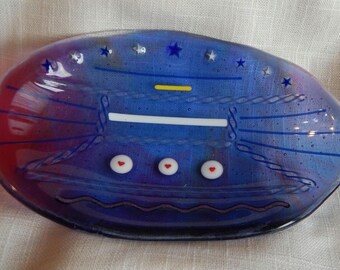 Clear blue to red oval plate 5.25 in x 4.5. Has hearts, stars and stripes patterns.