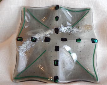 Transparent grey square dish with four wells. Embellished with dichro glass, frit and stringers.  6.25 x 6.25 inches.