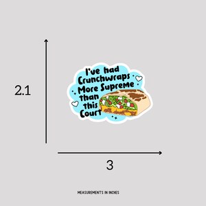 May include: A blue and white sticker with a cartoon image of a burrito and the text "I've had Crunchwraps More Supreme than this Court". The sticker is 3 inches wide and 2.1 inches tall.