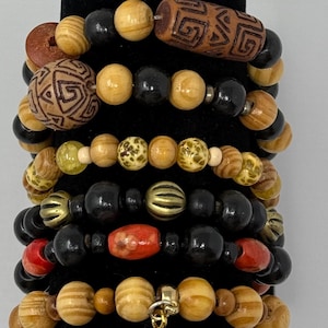Earthy Boho Style Handmade Wooden Beaded Bracelets with Artistic Carvings and Charms