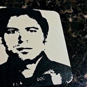 May include: Black and white silhouette of a person's face with the text "FLA DOC" on the bottom right corner.