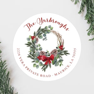 May include: Round white sticker with a red and green watercolor wreath with a red bow. The text "The Yarboroughs" is written in red cursive above the wreath. The address "2228 Vera Private Road, Maurice, LA 70555" is written in red below the wreath.