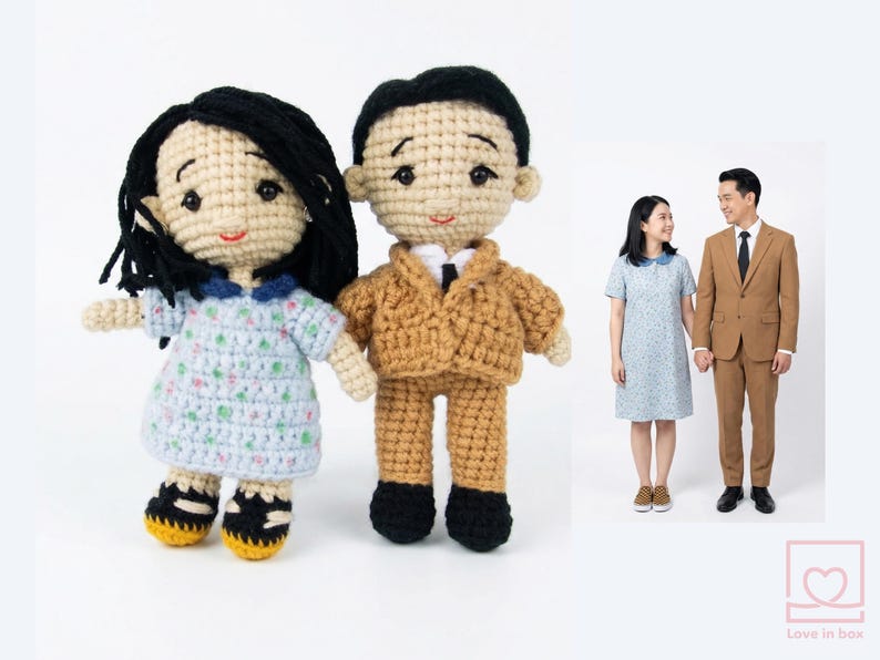 Close-up of a personalized amigurumi couple with custom details, perfect 1st anniversary (paper/cotton) gift created from reference photos.