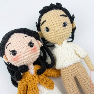 Custom amigurumi couple portrait dolls created from a photo, featuring a handmade miniature groom in a suit and bride in a white lace dress.