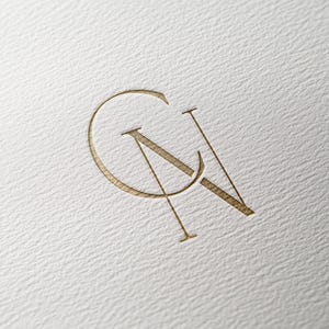May include: A gold monogram logo with the letters "CN" intertwined.