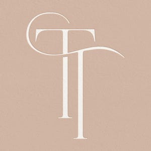 May include: A white stylized monogram of the letters "TT" with a curved line above the first "T".