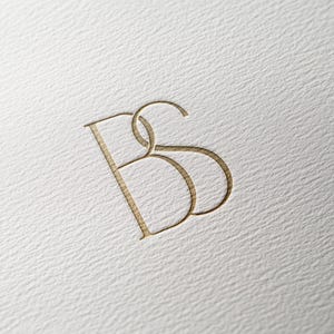 May include: A gold monogram logo with the letters "BS" intertwined.