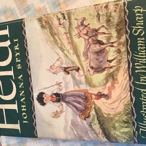 May include: Vintage hardcover book titled "Heidi" by Johanna Spyri, illustrated by William Sharp. The cover features a green border with white text and a colorful illustration of children and animals in a mountainous landscape.