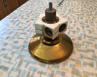 May include: Vintage brass ceiling light fixture with a white ceramic lamp holder. The fixture has a round base and a square lamp holder with two sockets. The fixture is likely from the mid-century era.