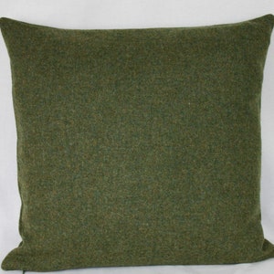 May include: A green square throw pillow with a soft, textured fabric.