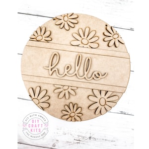 May include: A round wooden sign with the word "hello" in a cursive font. The sign is decorated with a pattern of daisy flowers.
