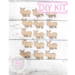 May include: A DIY craft kit featuring 15 wooden ant shapes. The ants are brown and have a simple design. The kit is labeled "DIY KIT" and "DIY CRAFT KITS".