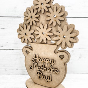 May include: Wooden cutout of a vase with flowers and the text "Happy Mother's Day!"