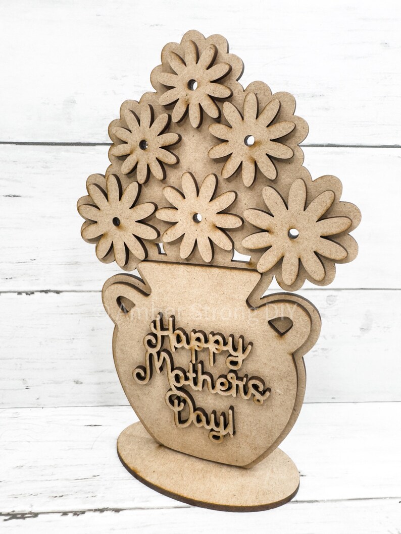 May include: Wooden cutout of a vase with flowers and the text "Happy Mother's Day!"