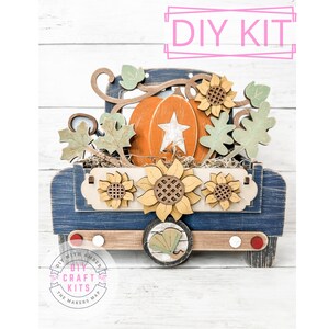 May include: DIY craft kit featuring a blue truck with a pumpkin and sunflowers. The truck is made of wood and has a rustic look. The kit includes all the pieces needed to assemble the truck, as well as instructions.  DIY with Amber The Makers Map.