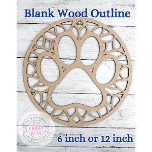 May include: A blank wood outline in the shape of a paw print, with decorative cutouts around the edges. The text "Blank Wood Outline" is at the top, and "6 inch or 12 inch" is at the bottom. The craft kit is from DIY with Amber.