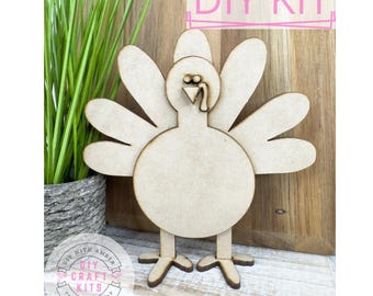 May include: DIY craft kit featuring a wooden turkey cutout. The turkey is brown and has a simple design. The kit includes all the necessary materials to create a festive Thanksgiving decoration.