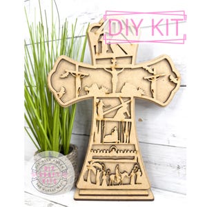 May include: DIY craft kit featuring a wooden cross with intricate laser cut designs depicting scenes from the Bible. The cross is unfinished and ready to be painted or stained.