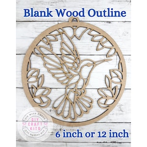 May include: A blank wood outline of a hummingbird in flight, surrounded by leaves and a circular frame. The text "Blank Wood Outline" is at the top, and "6 inch or 12 inch" is at the bottom. The DIY Craft Kits logo is in the lower left.