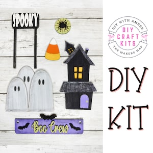 May include: A collection of Halloween-themed wooden cutouts, including ghosts, a haunted house, candy corn, and a sign that reads "Boo Crew." The word "Spooky" is also displayed. The items are part of a DIY craft kit.