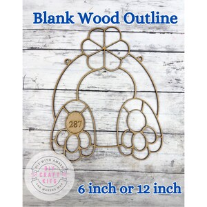 May include: A blank wood outline in the shape of a bunny with the text "Blank Wood Outline" at the top. The bunny outline has a flower-shaped head and two large feet. The number "287" is in the center of one foot. Available in 6 or 12 inches.