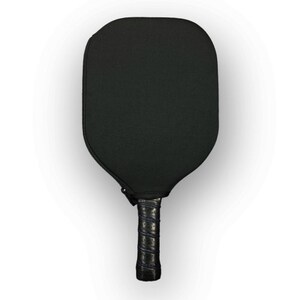 May include: A black pickleball paddle with a black grip. The paddle has a textured surface.