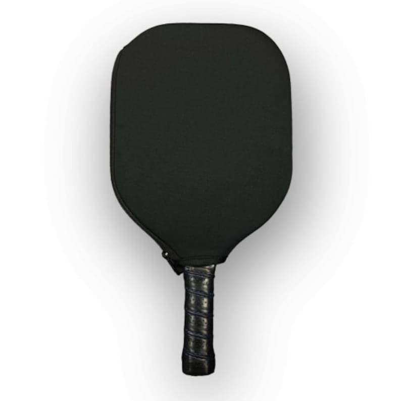 May include: A black pickleball paddle with a black grip. The paddle has a textured surface.