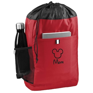 May include: Red drawstring backpack with a black mesh side pocket and a black zippered pocket on the front. The front pocket has a black Mickey Mouse head with the word "Mom" underneath.