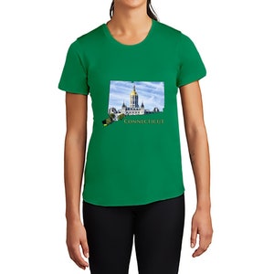 May include: A green t-shirt featuring a graphic of the state of Connecticut, with the state capitol building and the word "CONNECTICUT" in gold lettering.